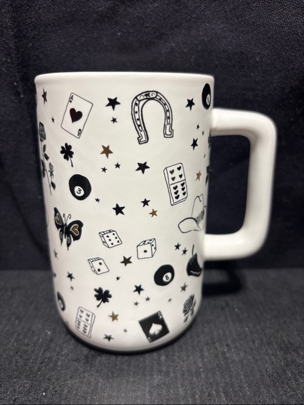 White Ceramic Mug with Black & Gold Lucky Charms Pattern. New without tag.